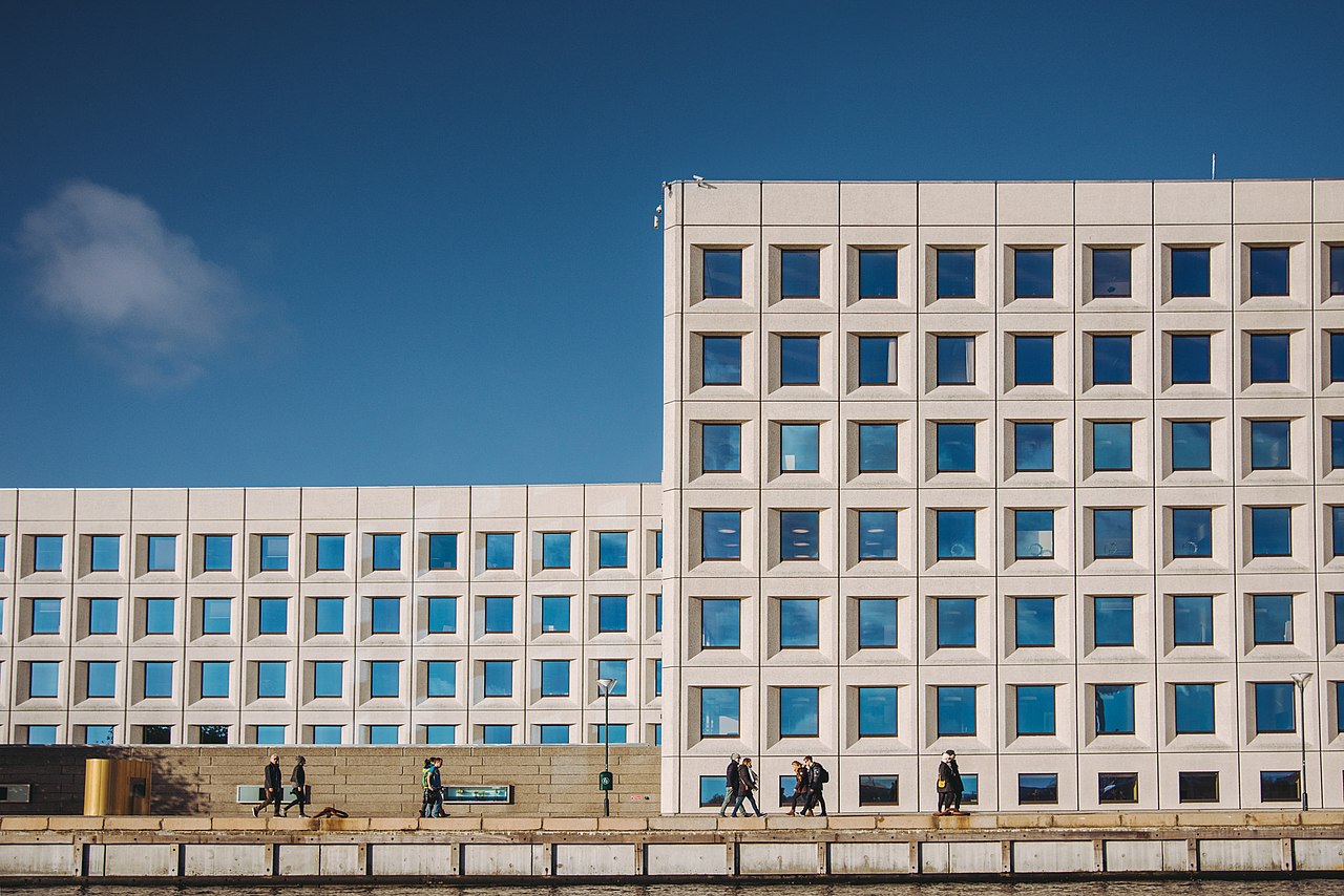 The A.P. Moller-Maersk headquarters building in Copenhagen, a modern multi-story waterfront building with a grid-like window pattern.