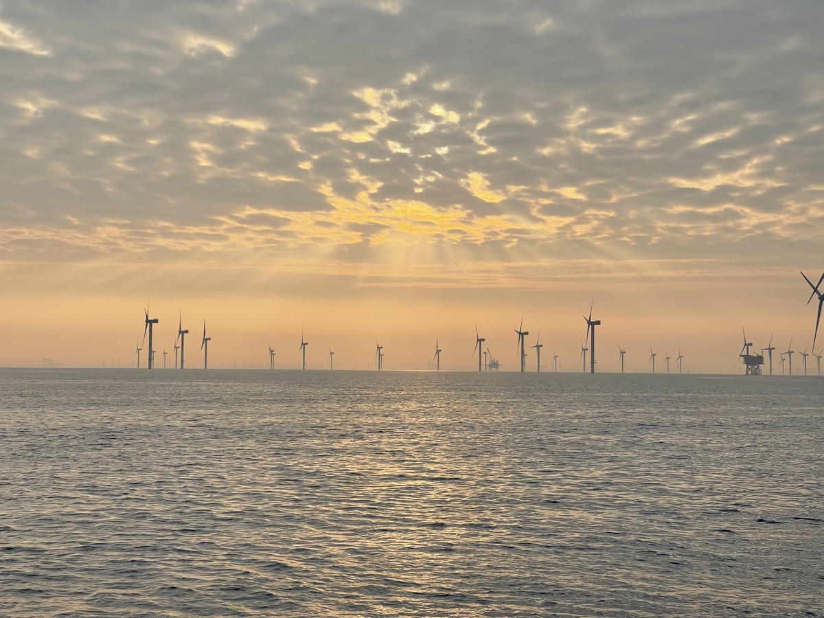 Offshore wind turbines at the Nordsee One wind farm in the North Sea at sunset