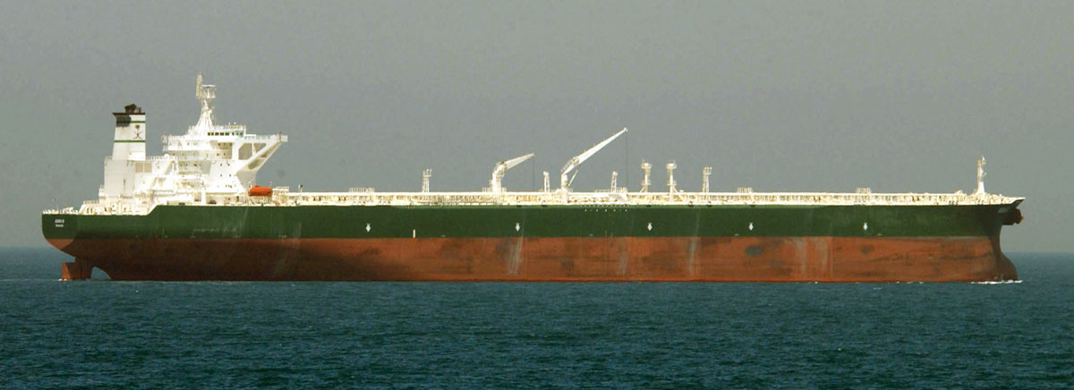 A large crude oil supertanker at sea, representing the global oil trade